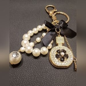 Elegant Pearl and Gold Keychain with Black Bow